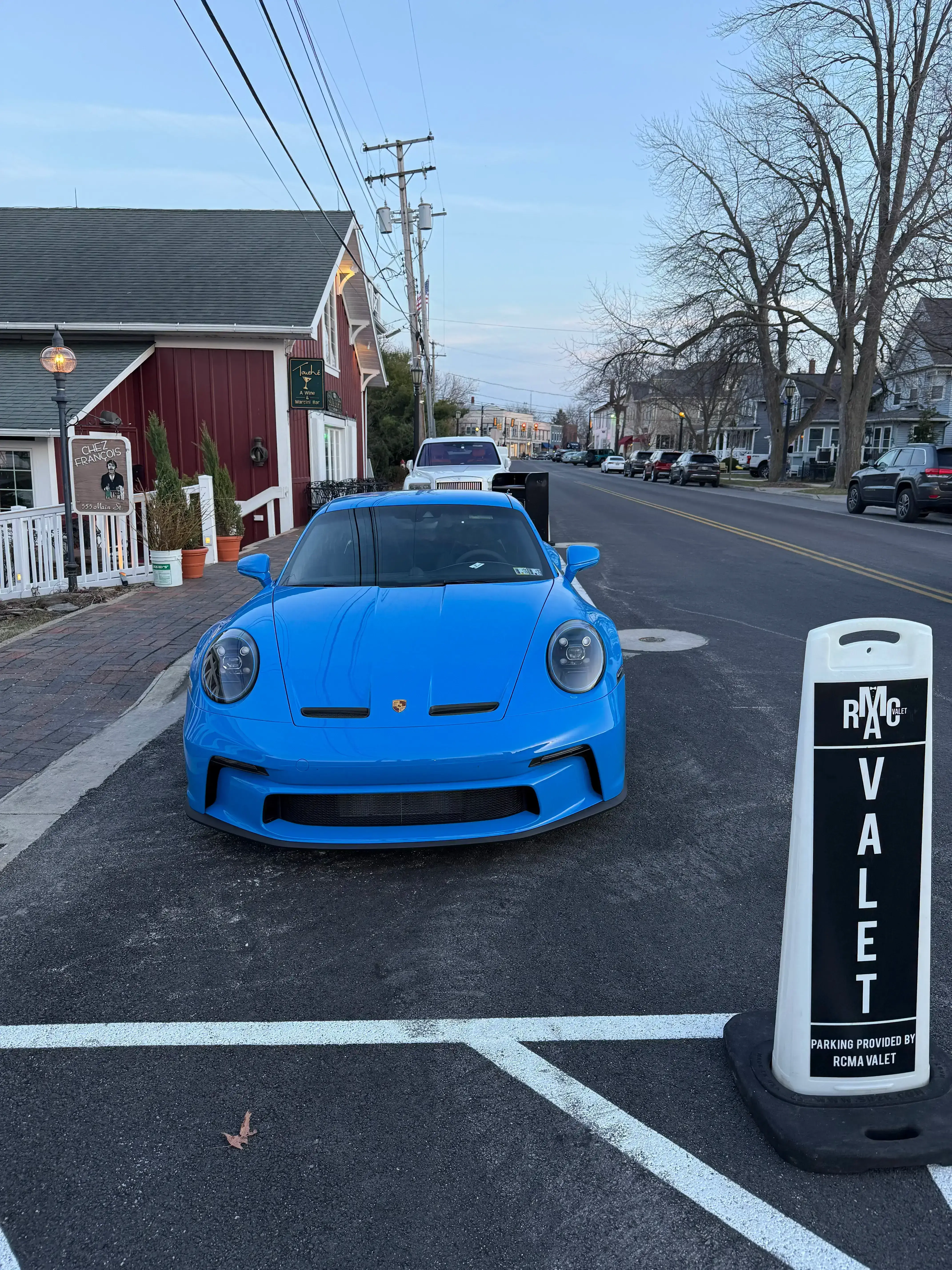 Blue Porsche at RCMA Valet lane near Chez Francois and Touche Bistro