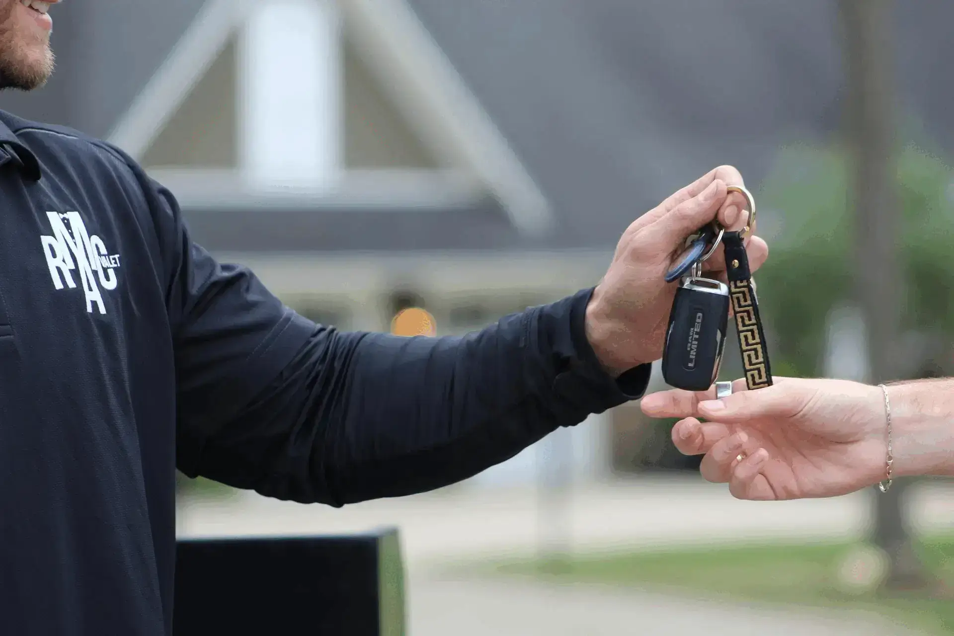 Close-up of RCMA Valet attendant handing keys to a guest